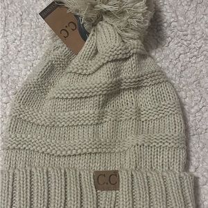 Beanie with Pom Pom never worn. Has tags!!paid over 30.